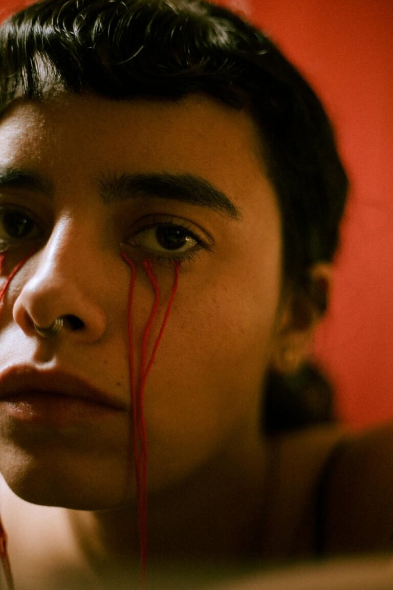 Close-up of Young Womans Face With Red Threads 